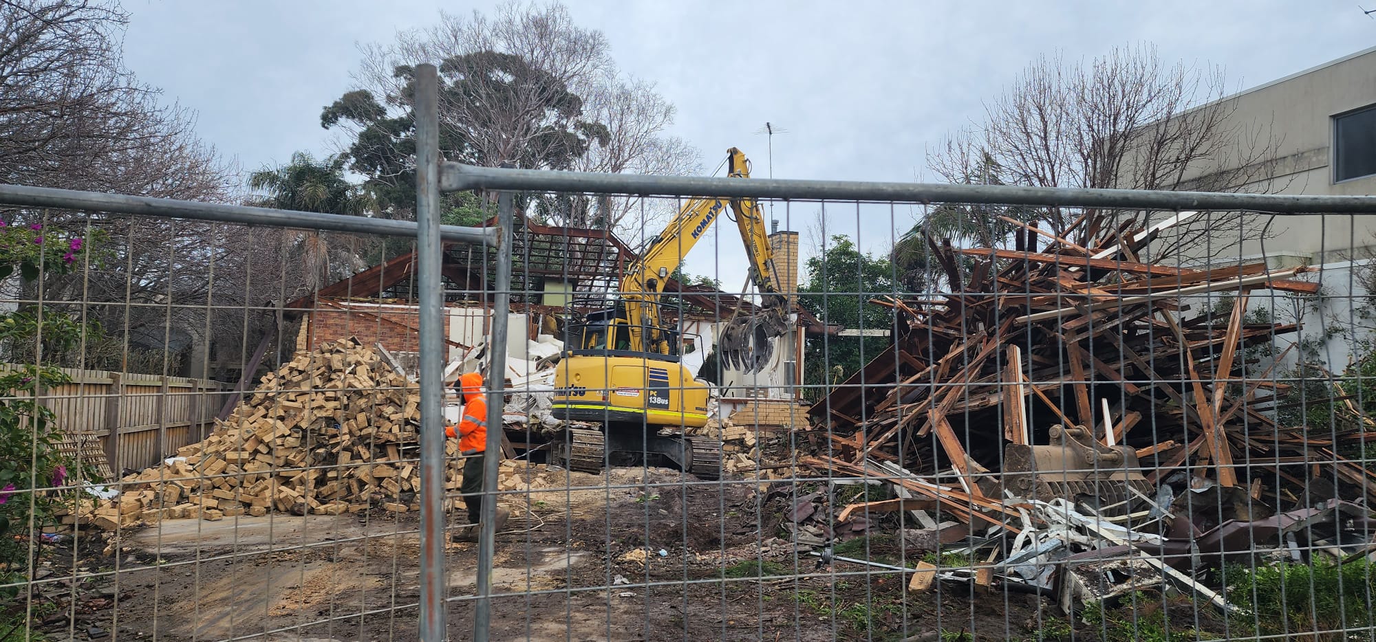 Excavator working through demolition material